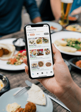 holding iphone 11 browsing food app